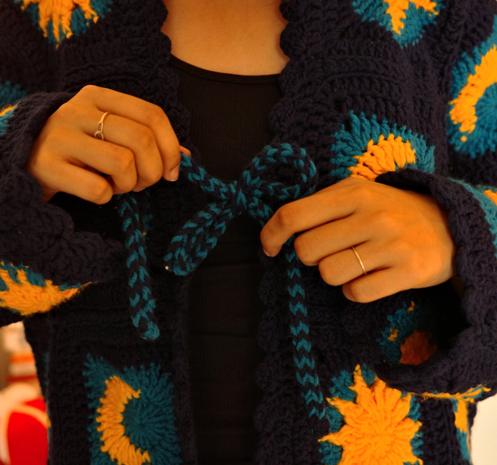 crochet granny square cardigan, with dark blue and golden yellow granny square pattern