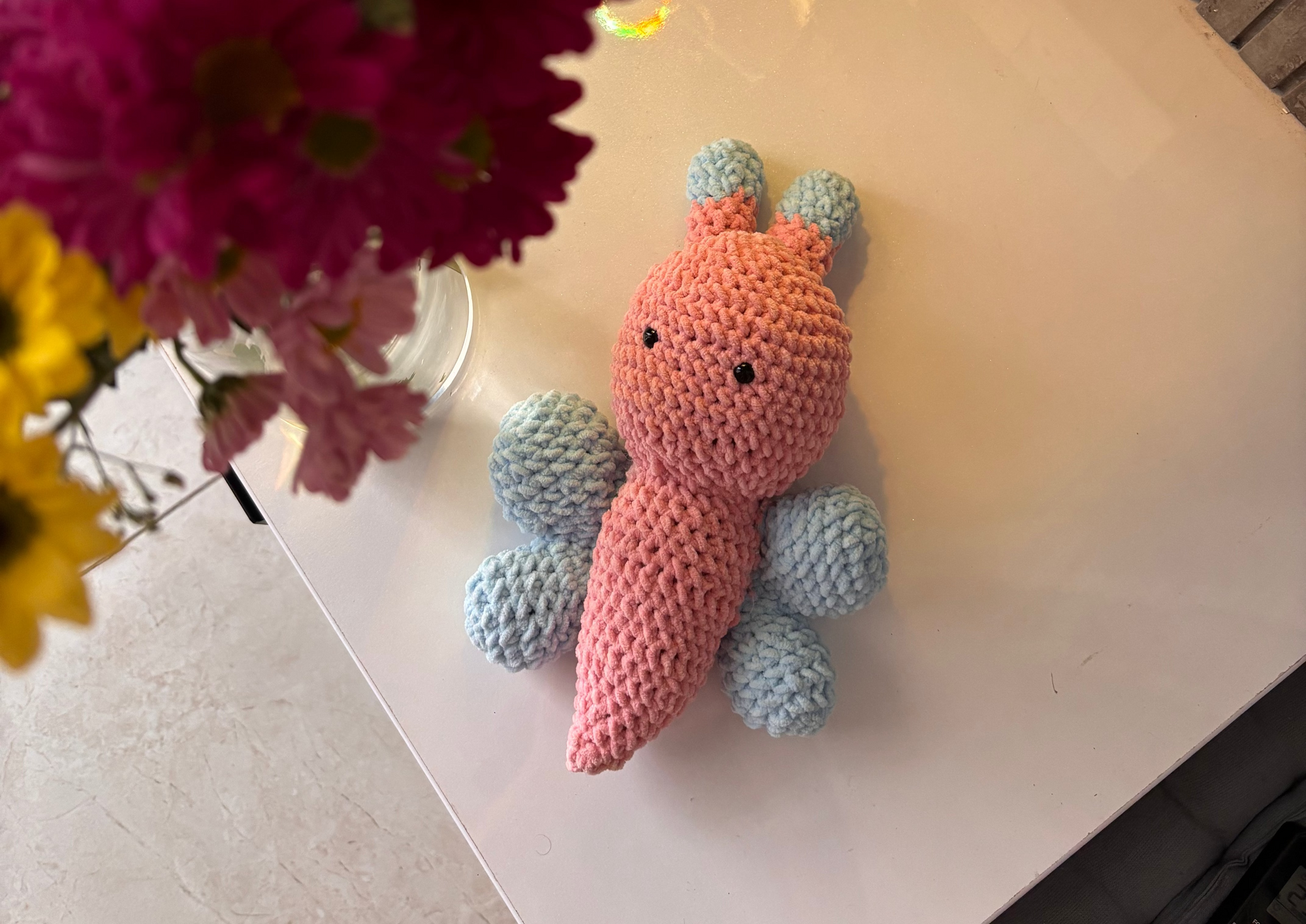 handmade crochet butterfly plushie in pink and blue, soft amigurumi toy with small wings and antennae