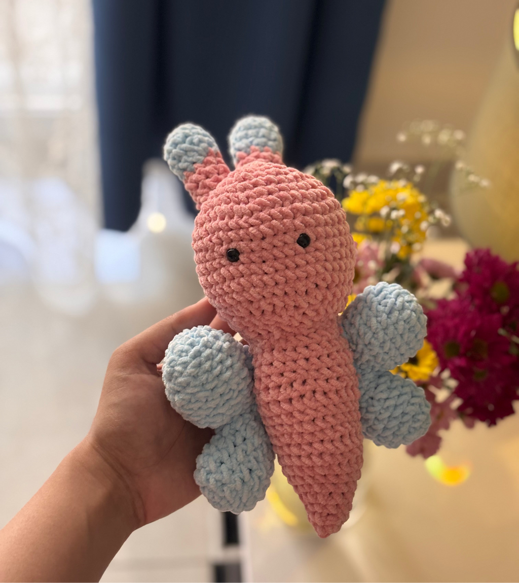 handmade crochet butterfly plushie in pink and blue, soft amigurumi toy with small wings and antennae