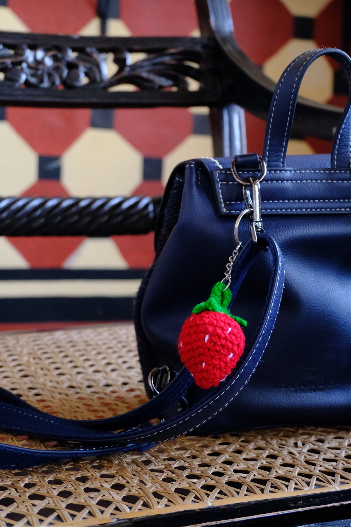 crochet strawberry keychain on a bagpack