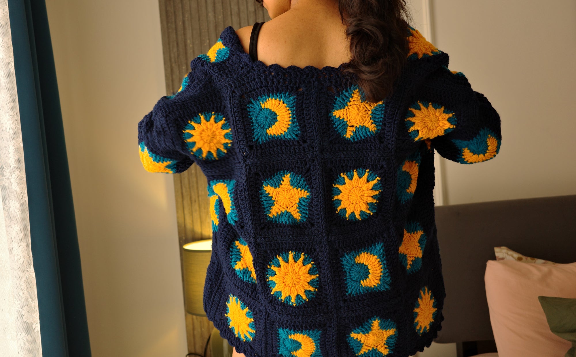 crochet granny square cardigan, with dark blue and golden yellow granny square pattern