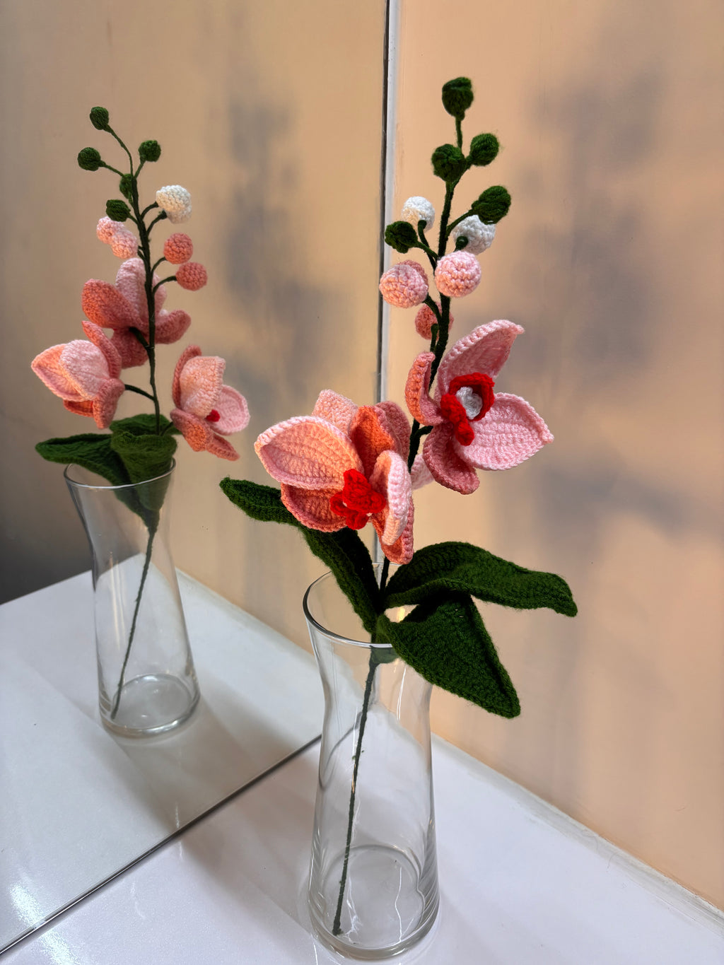 Knitted crochet pink orchid flowers.