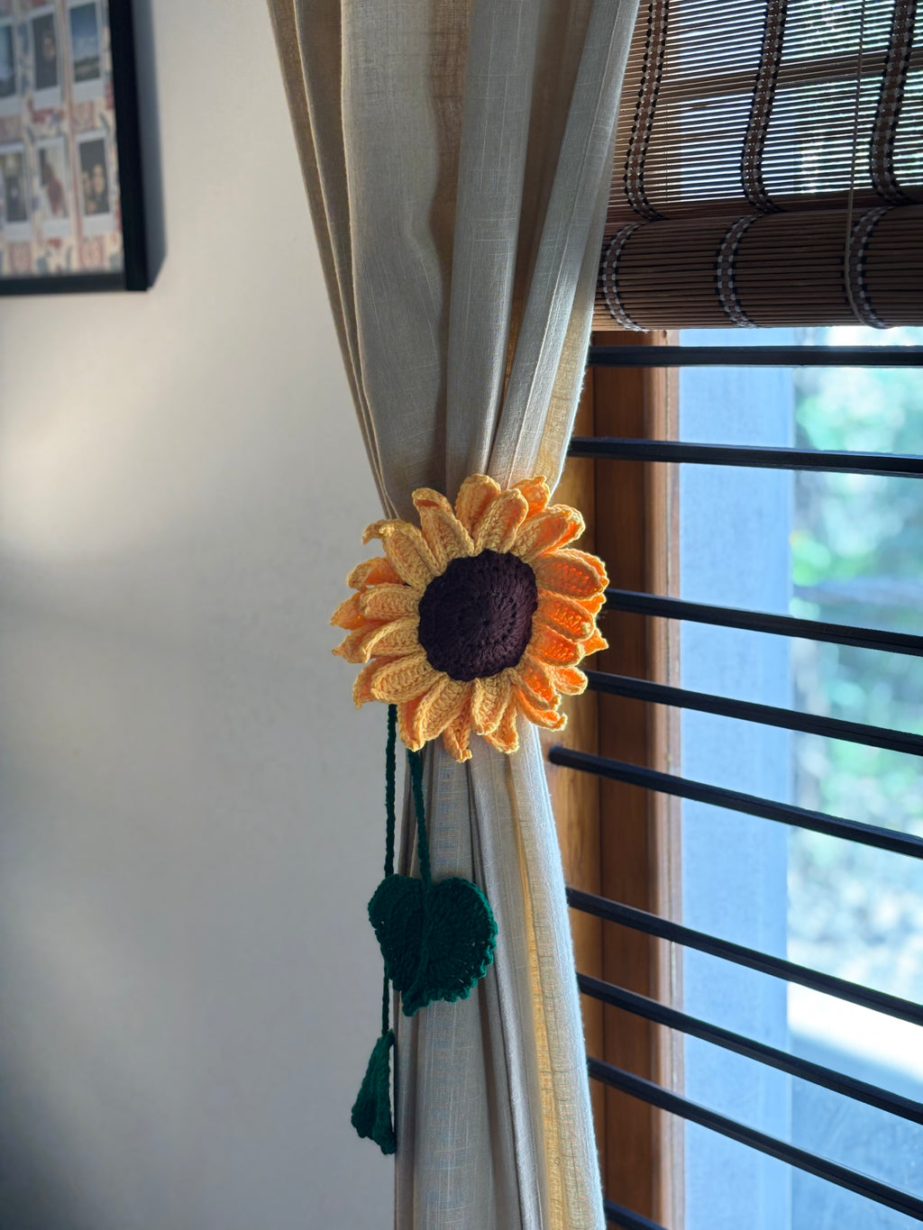 Sunflower-themed curtain tieback on a beige curtain with a window in the background