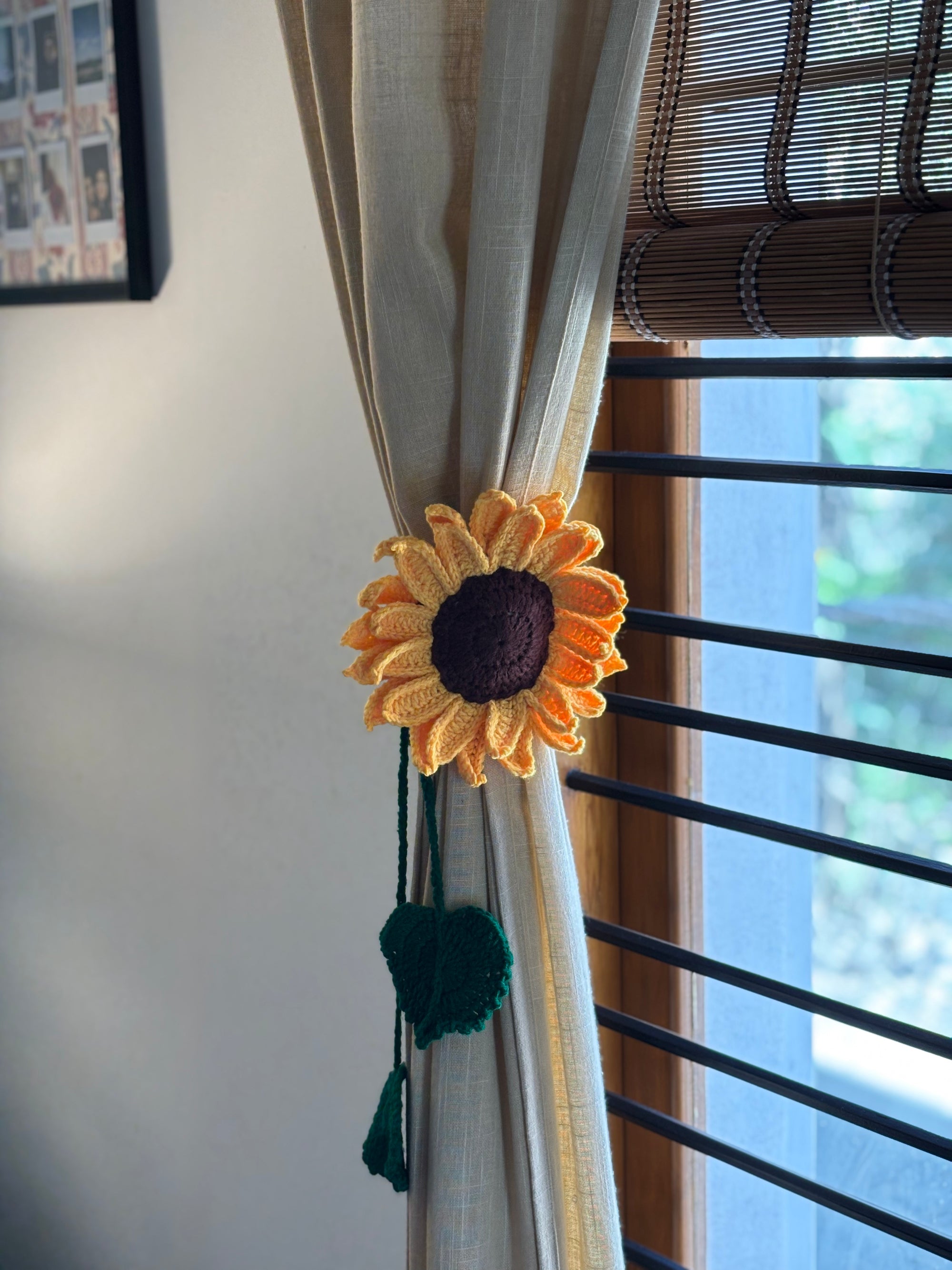 Sunflower-themed curtain tieback on a beige curtain with a window in the background